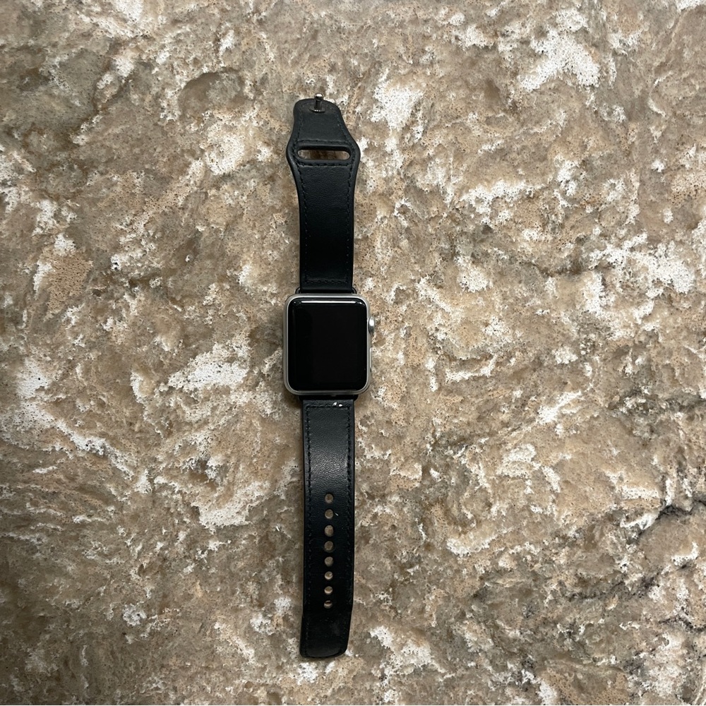 Apple watch Gen 1 with leather wristband. Works great Charger included.